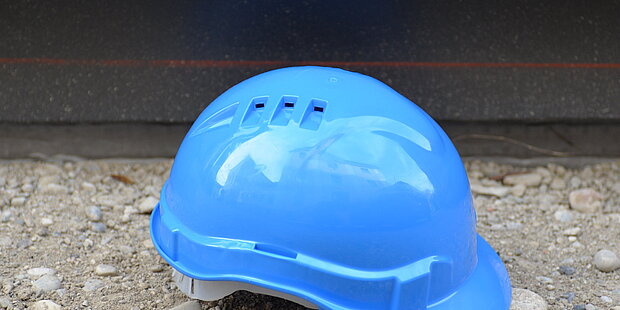 A blue hard hat in front of the museum