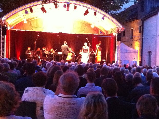 An atmospheric ambience in the castle courtyard, view of the stage
