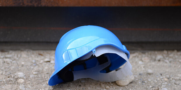 A blue hard hat in front of the museum